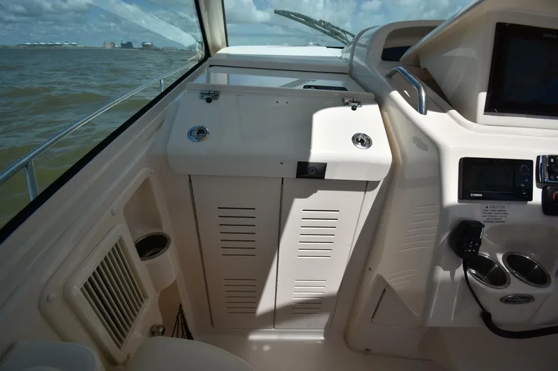 Policy Maker Yacht Photos Pics 2016 Grady-White Express 330 boat interior with control panel and storage compartment.