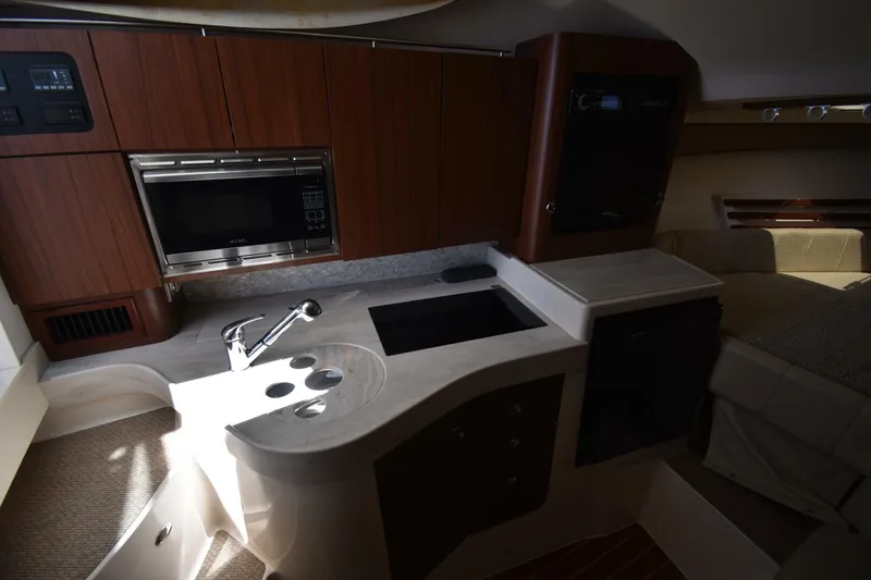 Policy Maker Yacht Photos Pics 2016 Grady-White Express 330 interior kitchen with sink, microwave, and cabinetry.