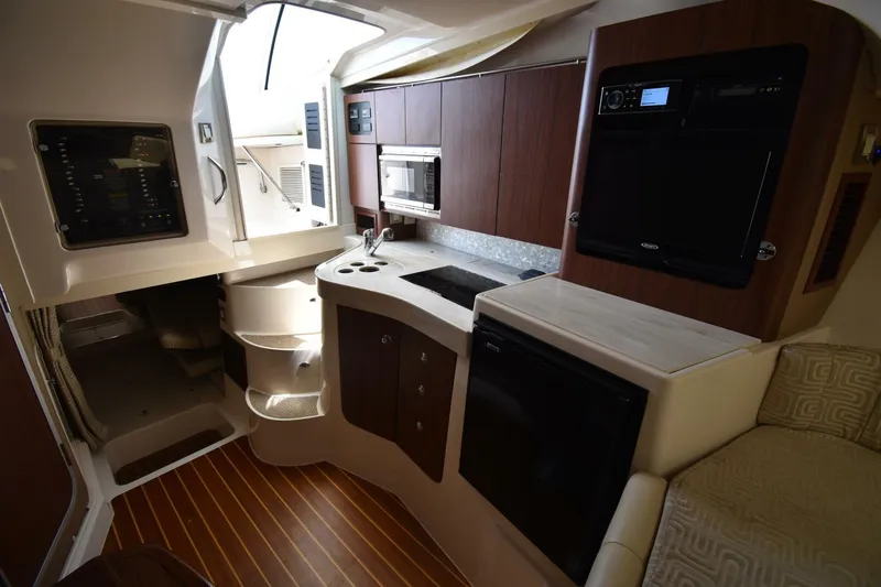 Policy Maker Yacht Photos Pics 2016 Grady-White Express 330 interior with kitchenette, microwave, and seating area.