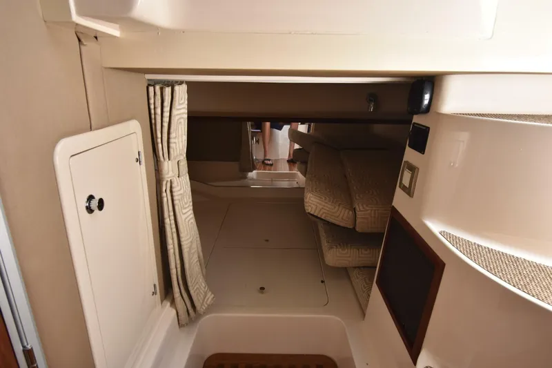 Policy Maker Yacht Photos Pics 2016 Grady-White Express 330 cabin interior with cozy seating and storage.