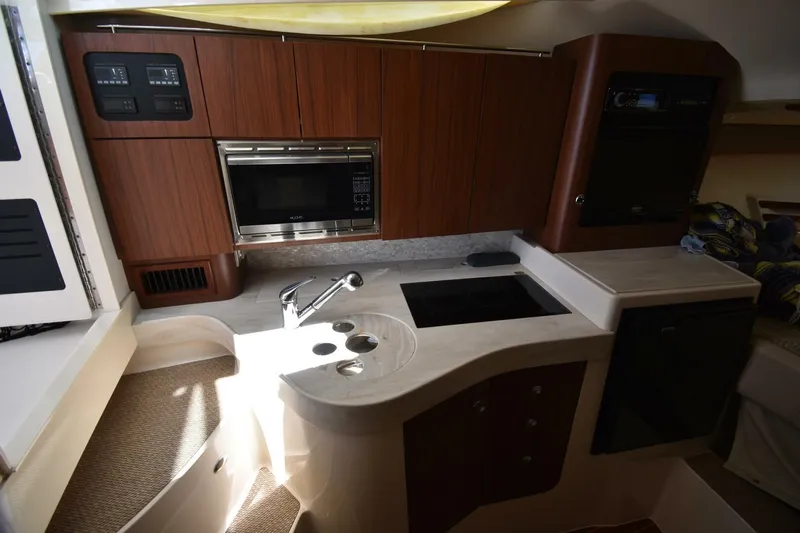 Policy Maker Yacht Photos Pics 2016 Grady-White Express 330 boat kitchen with microwave, sink, and stove.