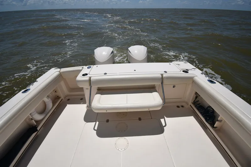 Policy Maker Yacht Photos Pics 2016 Grady-White Express 330 boat deck with twin engines on open water.