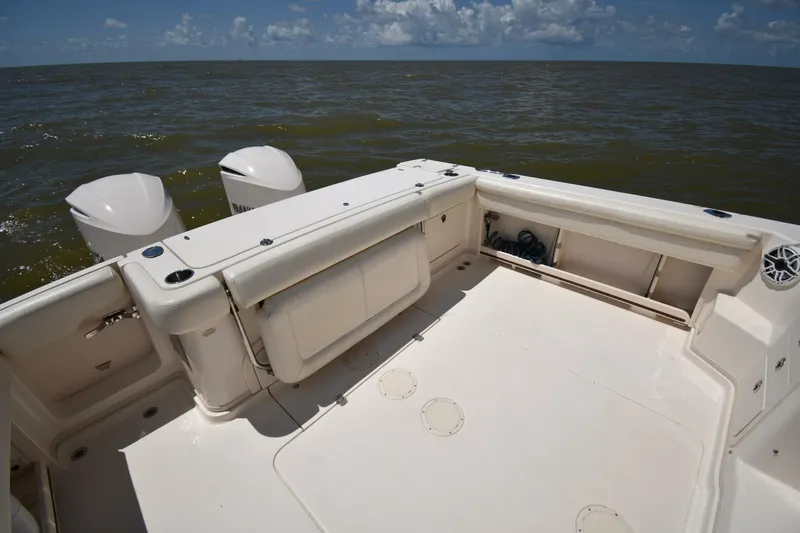 Policy Maker Yacht Photos Pics 2016 Grady-White Express 330 boat deck with twin engines on open water.