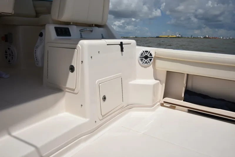 Policy Maker Yacht Photos Pics 2016 Grady-White Express 330 boat interior with storage compartments and speaker, overlooking water.