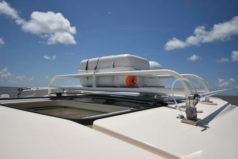 Policy Maker Yacht Photos Pics 2016 Grady-White Express 330 boat roof with life raft under blue sky.