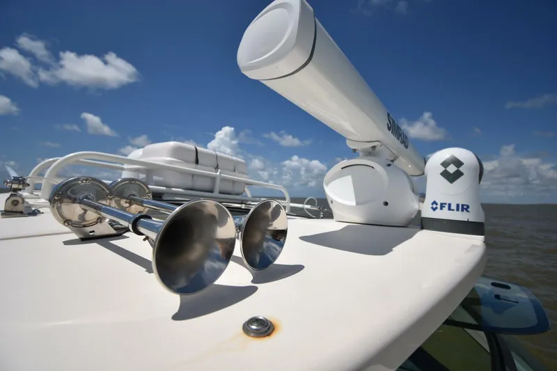 Policy Maker Yacht Photos Pics 2016 Grady-White Express 330 boat with radar and horns under a clear blue sky.