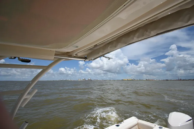 Policy Maker Yacht Photos Pics 2016 Grady-White Express 330 boat on open water under cloudy sky.