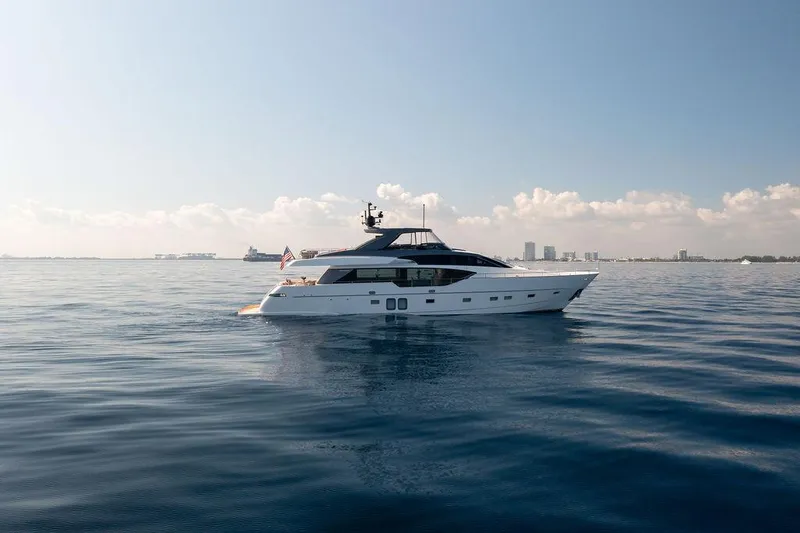 Sanlorenzo Sl86 Yacht Photos Pics 2022 Sanlorenzo SL86 yacht on calm ocean with city skyline in background.