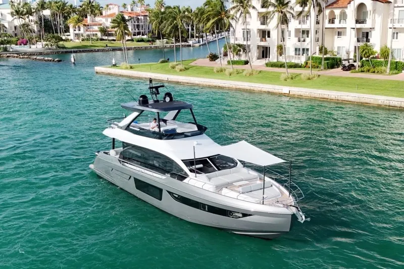  Yacht Photos Pics 2023 Azimut Fly 68 yacht cruising near luxury waterfront homes.