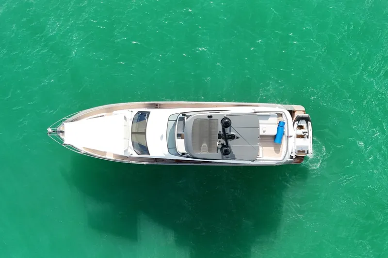  Yacht Photos Pics Aerial view of 2023 Azimut Fly 68 yacht on turquoise water.