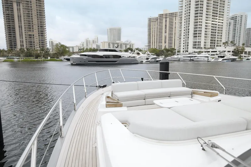  Yacht Photos Pics Luxurious 2023 Azimut Fly 68 yacht docked in a modern marina with cityscape backdrop.