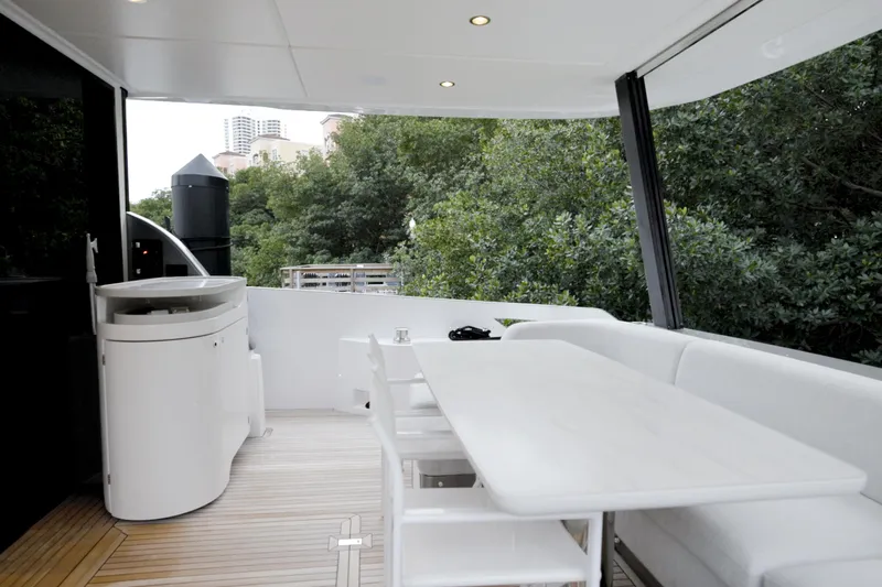  Yacht Photos Pics Luxurious 2023 Azimut Fly 68 yacht deck with elegant seating and scenic views.