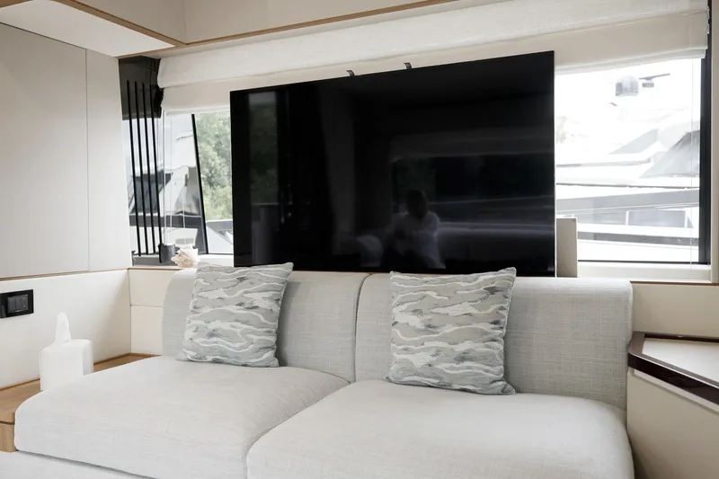  Yacht Photos Pics Luxurious interior of 2023 Azimut Fly 68 yacht with modern sofa and large TV.