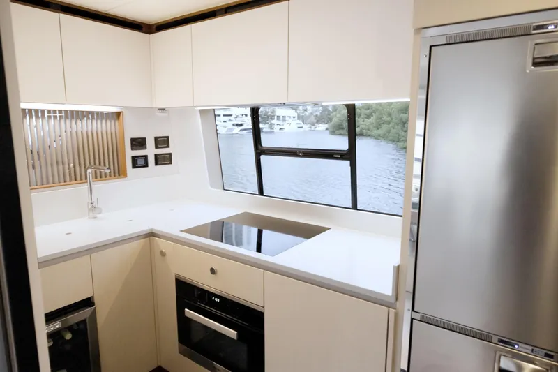  Yacht Photos Pics Modern kitchen interior of 2023 Azimut Fly 68 yacht with sleek appliances and waterfront view.