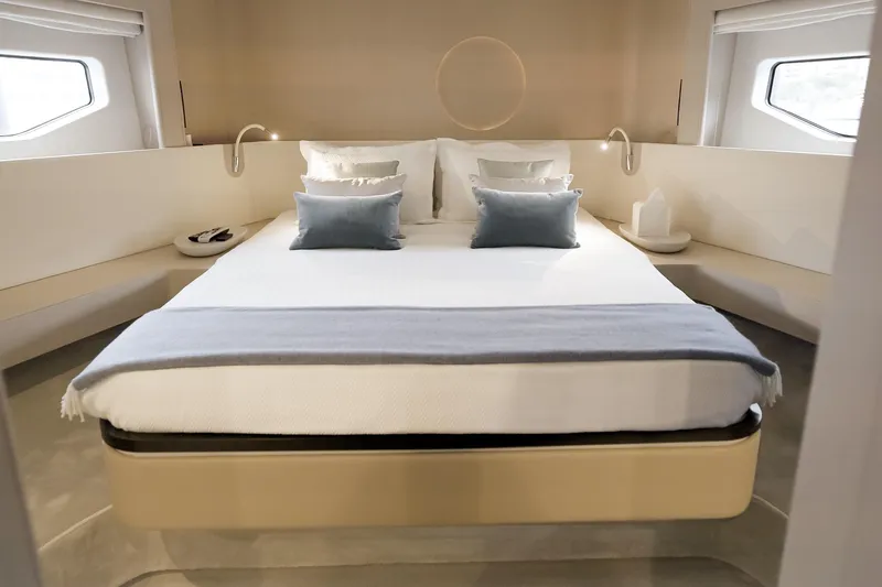  Yacht Photos Pics Luxurious bedroom interior of 2023 Azimut Fly 68 yacht with modern design and cozy bedding.
