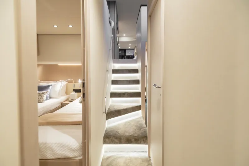  Yacht Photos Pics Luxurious interior of 2023 Azimut Fly 68 yacht with elegant staircase and cozy bedroom.