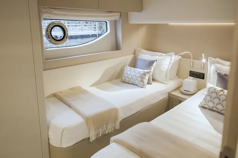  Yacht Photos Pics Luxurious 2023 Azimut Fly 68 yacht cabin with twin beds and elegant decor.
