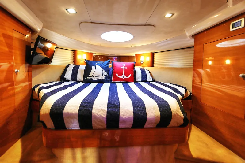 Yacht Photos Pics Luxurious cabin interior of 2008 Cranchi Mediterranee 43 yacht with nautical-themed bedding.