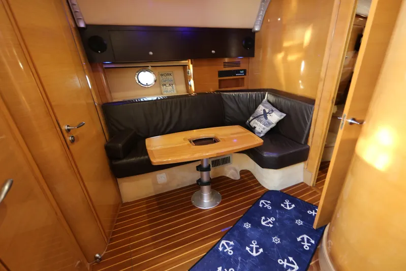 Yacht Photos Pics Interior of 2008 Cranchi Mediterranee 43 yacht with cozy seating and nautical decor.