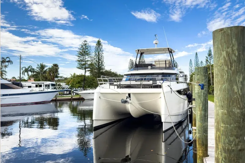  Yacht Photos Pics 2023 Prestige M48 yacht docked in a serene marina setting.