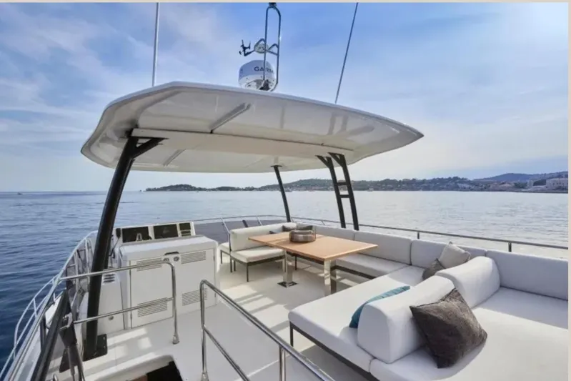  Yacht Photos Pics Luxurious 2023 Prestige M48 yacht with spacious deck and seating, cruising on calm waters.