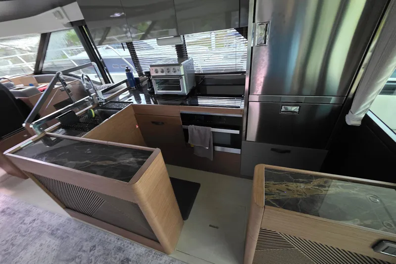  Yacht Photos Pics Modern kitchen interior of 2023 Prestige M48 yacht with sleek appliances and stylish design.