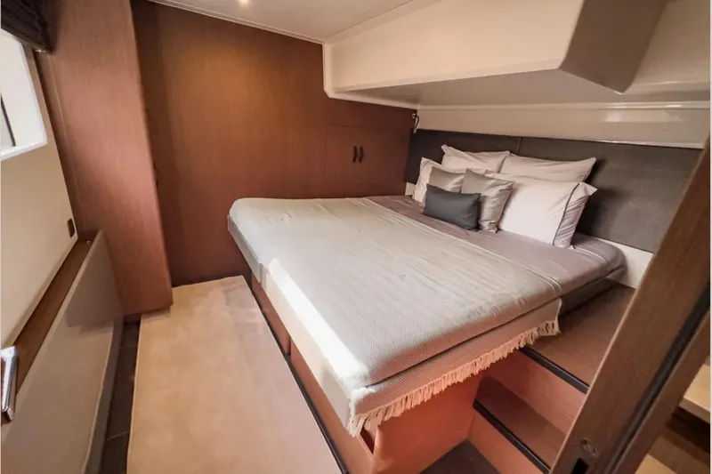  Yacht Photos Pics Luxurious bedroom interior of 2023 Prestige M48 yacht with cozy bedding and modern design.