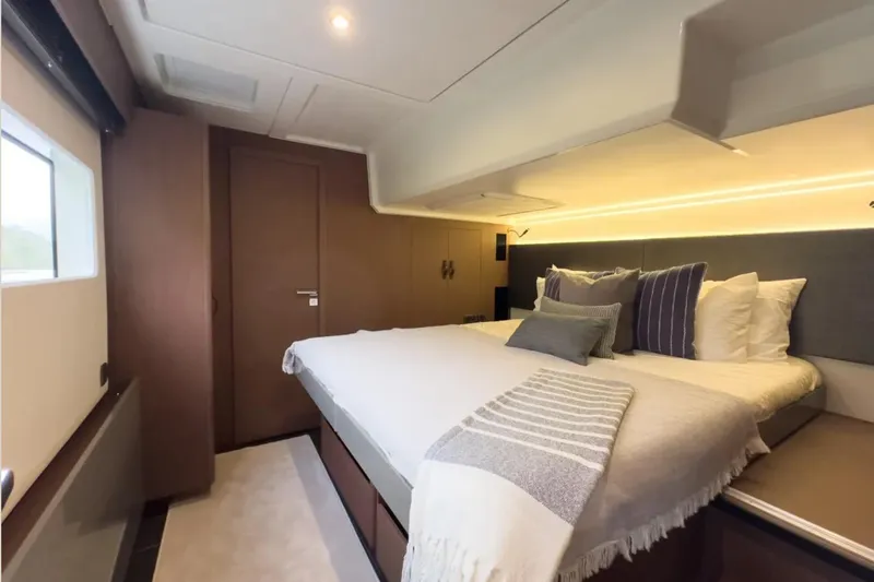  Yacht Photos Pics Luxurious bedroom interior of 2023 Prestige M48 yacht with modern design and cozy bedding.