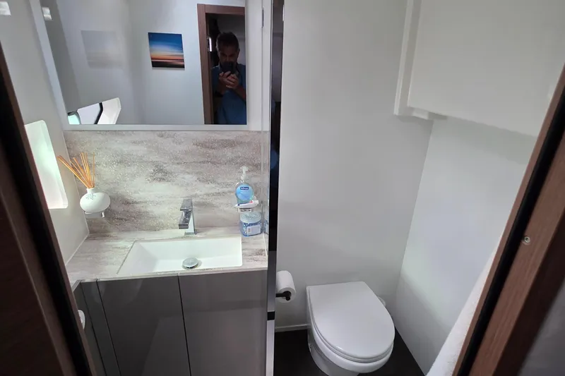  Yacht Photos Pics Modern bathroom in 2023 Prestige M48 yacht with sleek sink and toilet design.