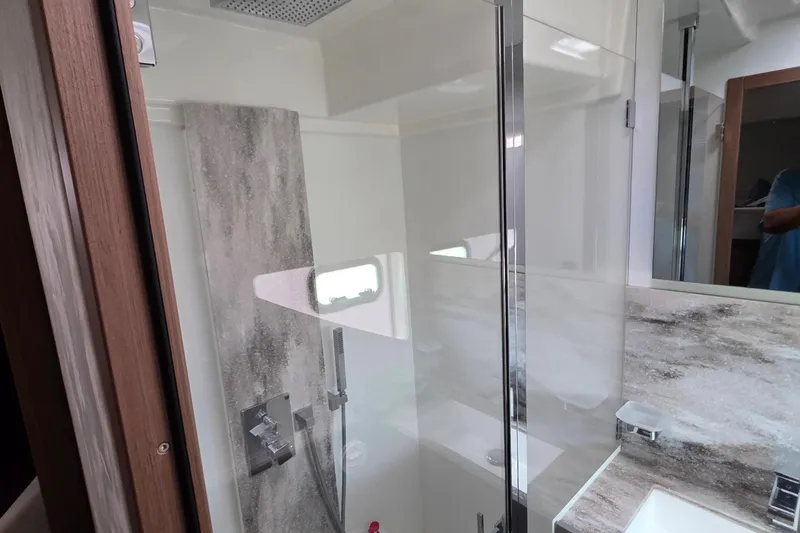  Yacht Photos Pics Modern bathroom interior in 2023 Prestige M48 yacht, featuring sleek glass shower and elegant fixtures.