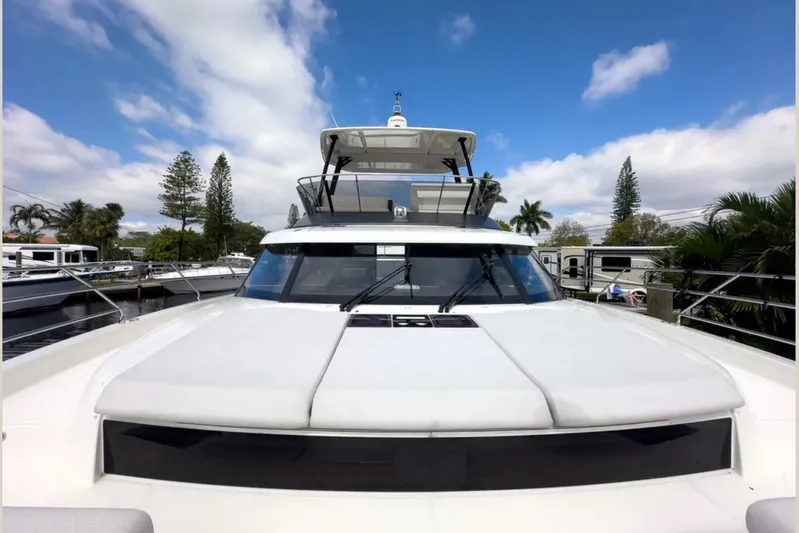  Yacht Photos Pics Luxury 2023 Prestige M48 yacht with sleek design, docked under a blue sky.