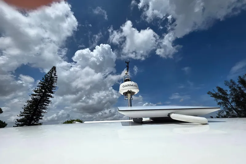  Yacht Photos Pics Rooftop Garmin antenna on 2023 Prestige M48 yacht under cloudy sky.