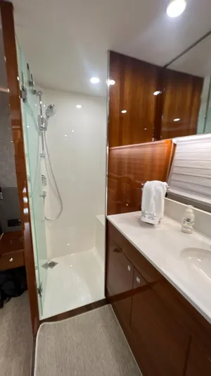 Trigal Yacht Photos Pics Luxurious bathroom in 2021 Maritimo X60 yacht with modern shower and sleek wood finishes.