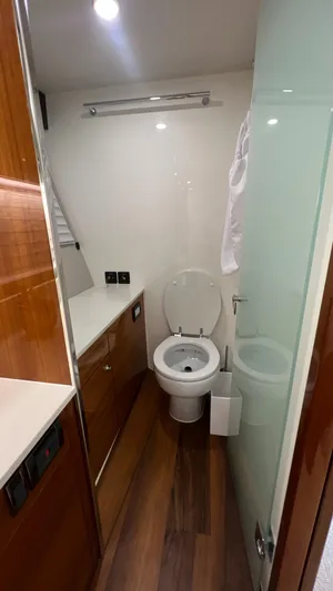 Trigal Yacht Photos Pics 2021 Maritimo X60 yacht bathroom with modern fixtures and wooden accents.