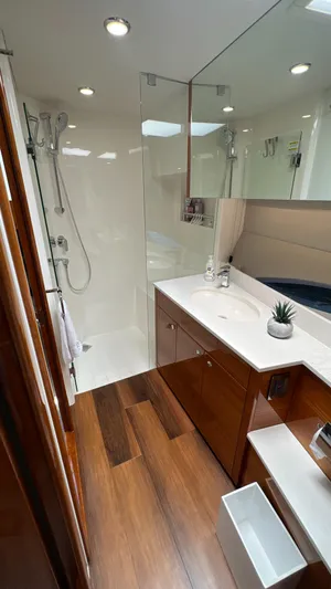 Trigal Yacht Photos Pics Luxurious bathroom in 2021 Maritimo X60 yacht with modern fixtures and wooden flooring.