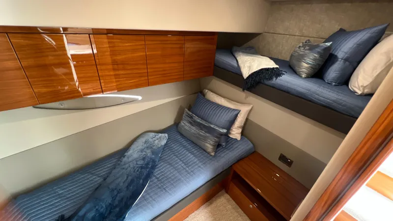 Trigal Yacht Photos Pics Luxurious cabin interior of 2021 Maritimo X60 yacht with cozy bedding and wooden accents.