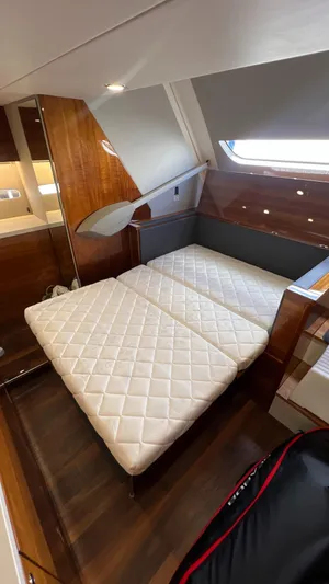 Trigal Yacht Photos Pics 2021 Maritimo X60 yacht interior with luxurious twin beds and wooden accents.