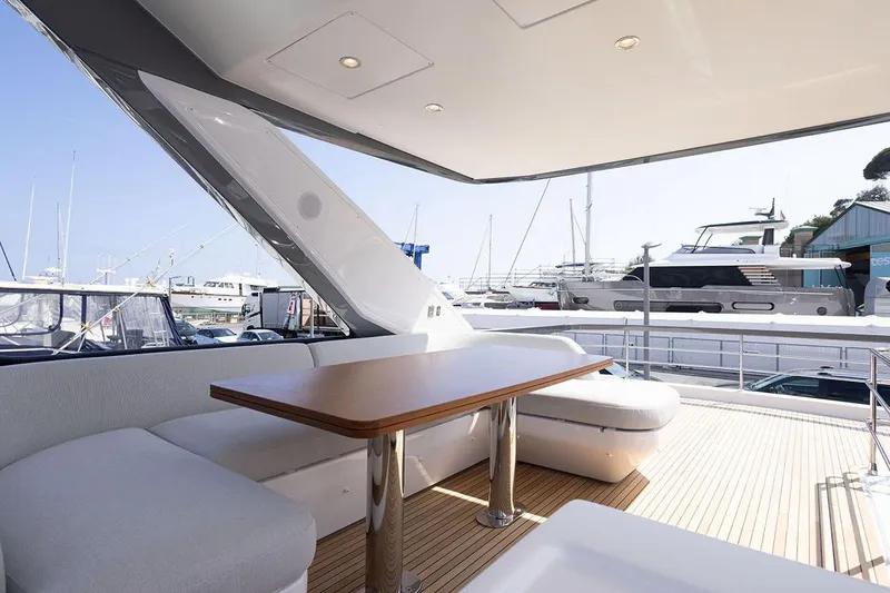  Yacht Photos Pics Luxurious 2025 Azimut Fly 68 yacht deck with elegant seating and table.