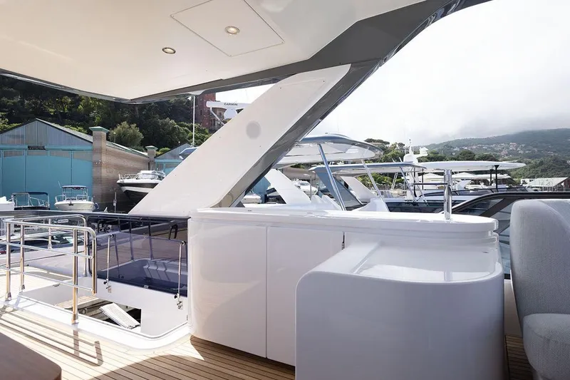  Yacht Photos Pics Luxurious 2025 Azimut Fly 68 yacht deck with modern design and scenic marina view.