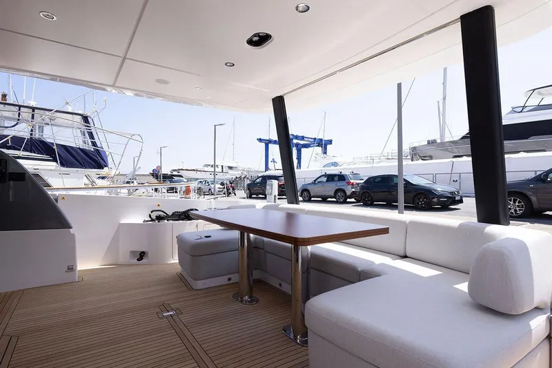 Yacht Photos Pics Luxurious Azimut Fly 68 yacht interior, featuring elegant seating and a wooden table, dockside view.