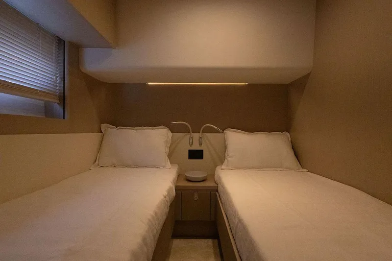  Yacht Photos Pics Luxurious twin cabin interior of 2025 Azimut Fly 68 yacht, featuring elegant bedding.