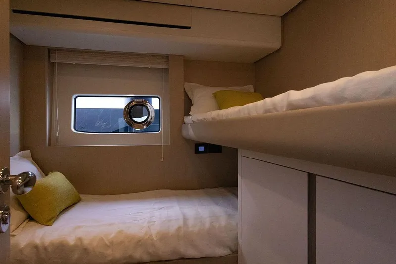  Yacht Photos Pics Interior of 2025 Azimut Fly 68 yacht cabin with bunk beds and window.
