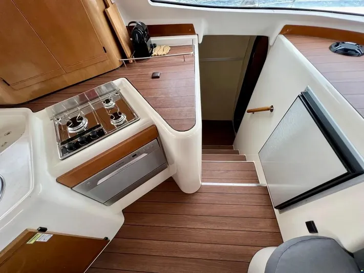  Yacht Photos Pics Interior of 2005 Fountaine Pajot LAVEZZI 40 catamaran with wooden flooring and compact kitchen.