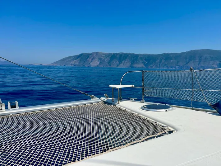  Yacht Photos Pics Catamaran deck view, Fountaine Pajot LAVEZZI 40, 2005, with ocean and mountain backdrop.