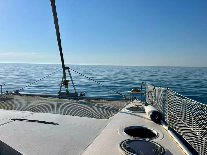  Yacht Photos Pics 2005 Fountaine Pajot LAVEZZI 40 catamaran sailing on calm sea under clear blue sky.