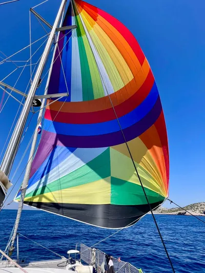  Yacht Photos Pics Colorful spinnaker sail on 2005 Fountaine Pajot LAVEZZI 40 catamaran against clear blue sky.