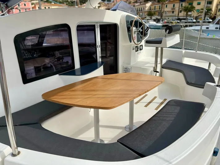  Yacht Photos Pics 2005 Fountaine Pajot LAVEZZI 40 catamaran cockpit with seating and wooden table.