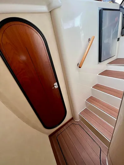  Yacht Photos Pics Interior of 2005 Fountaine Pajot LAVEZZI 40 yacht, featuring wooden door and stairs.