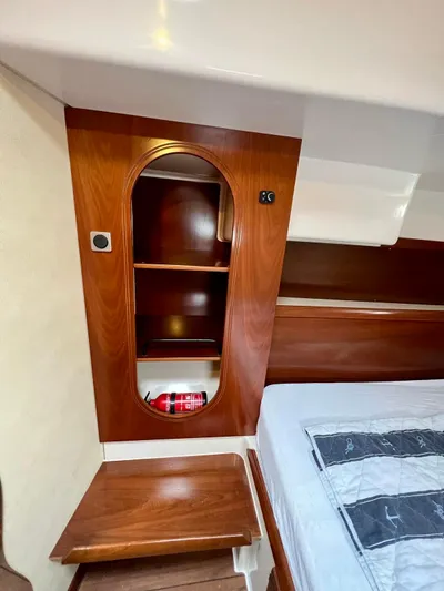  Yacht Photos Pics Interior of 2005 Fountaine Pajot LAVEZZI 40, featuring wooden cabinetry and a neatly made bed.