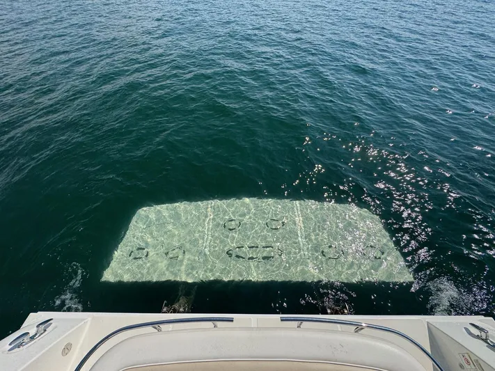 Why Knot Yacht Photos Pics 2012 Sea Ray 540 Sundancer swim platform submerged in clear ocean water.
